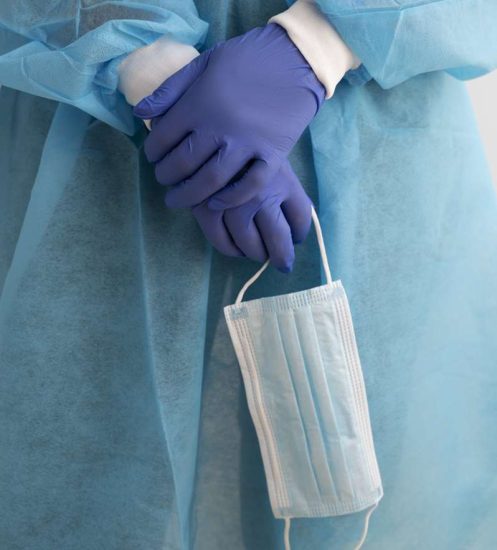 front-view-doctor-holding-face-mask